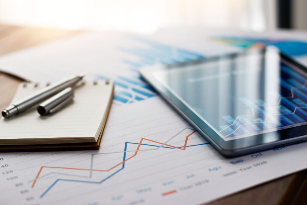 Graphs and Electronics on a Table Depicting eCommerce and Warehousing Trends