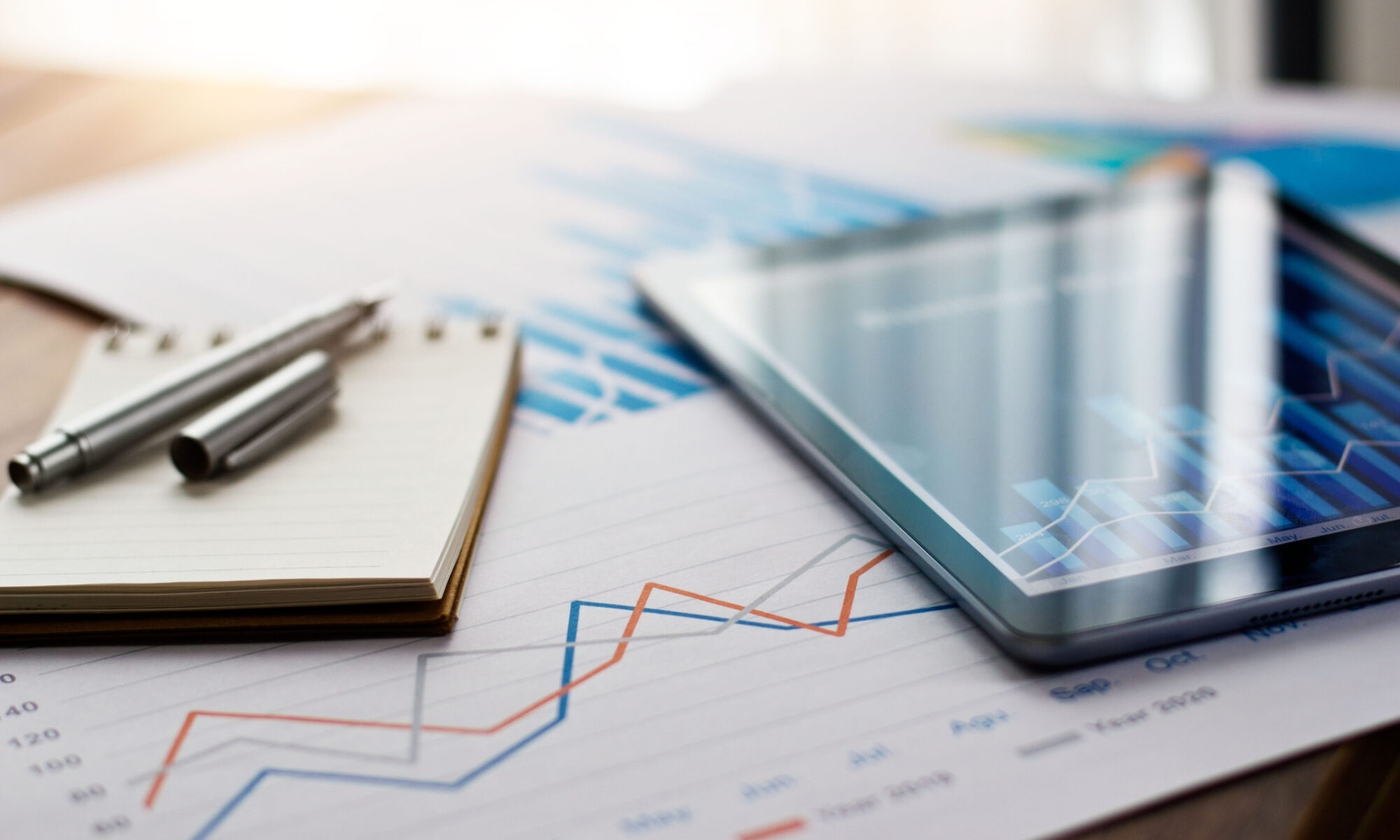 Graphs and Electronics on a Table Depicting eCommerce and Warehousing Trends