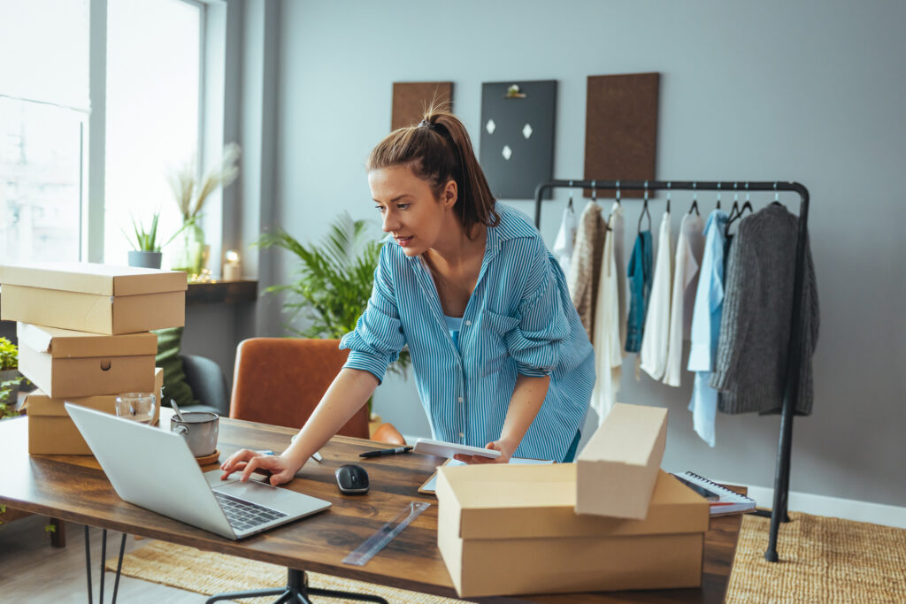 Women, owner of small business packing product in boxes