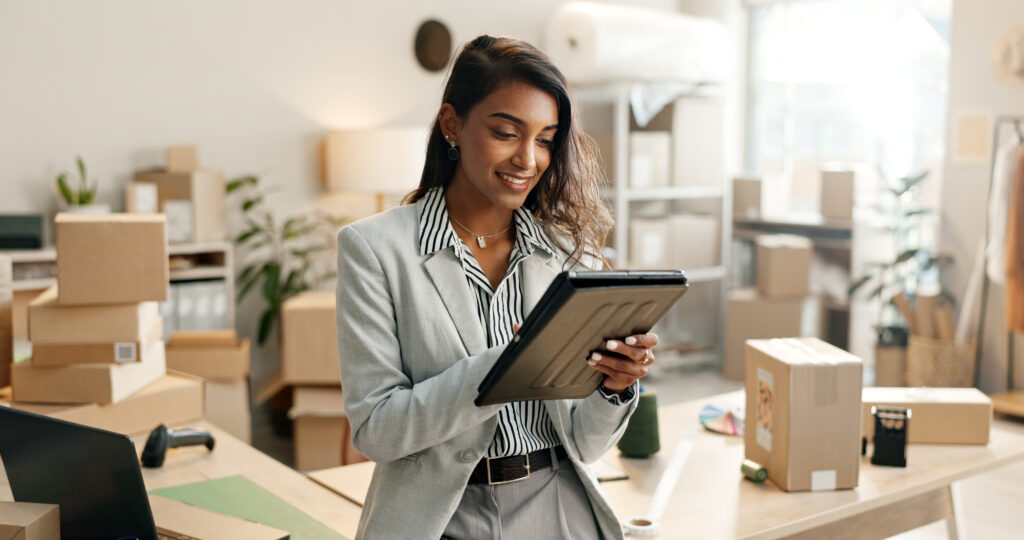 Small business owner looking at a tablet for family owned fulfillment partners