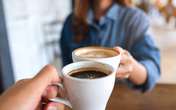Couple enjoying coffee after fixing their Keurig.